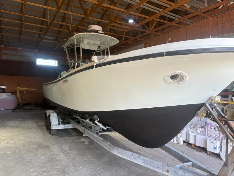 Slide: The Image of 1982 Master Marine 28 Center Console boat on trailer in storage facility. - 2