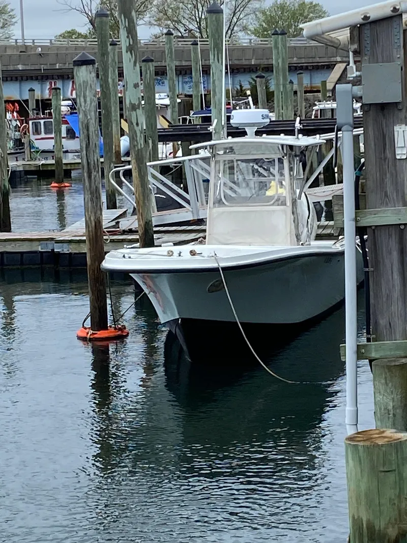 Slide: The Image of 1982 Master Marine 28 Center Console boat docked in a marina. - 5