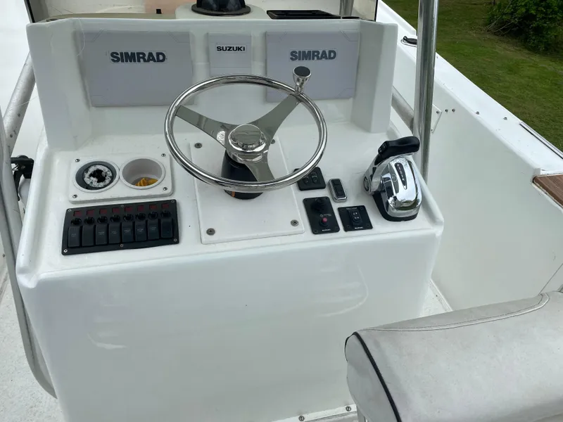 Slide: The Image of 1982 Master Marine 28 Center Console helm with Simrad electronics and Suzuki controls. - 8