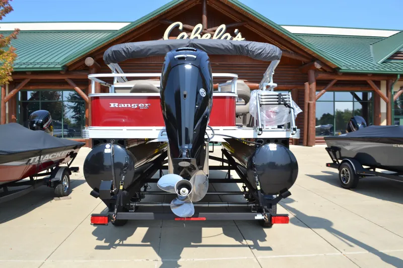 Slide: The Image of 2024 Ranger Reata 200F boat displayed outside Cabela's store. - 1