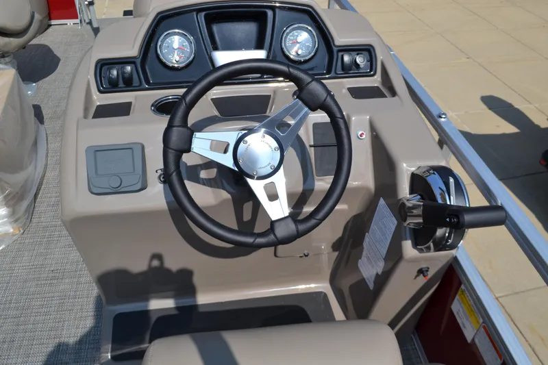 Slide: The Image of 2024 Ranger Reata 200F boat dashboard with steering wheel and control panel. - 2