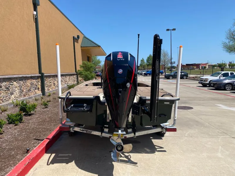 Slide: The Image of 2025 Mako 18 Pro Skiff Backwater Edition on trailer, parked outdoors. - 2