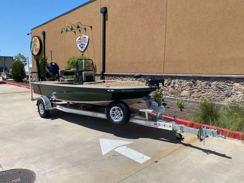 Slide: The Image of 2025 Mako 18 Pro Skiff Backwater Edition on trailer, parked outside a building. - 3