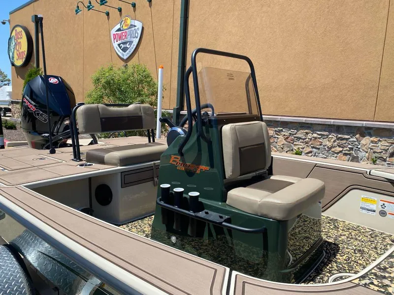 Slide: The Image of 2025 Mako 18 Pro Skiff Backwater Edition boat with seating and console, displayed outdoors. - 6