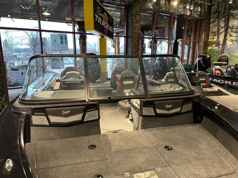 Slide: The Image of 2024 Ranger VX1788 WT boat interior with seating and windshield in showroom. - 2