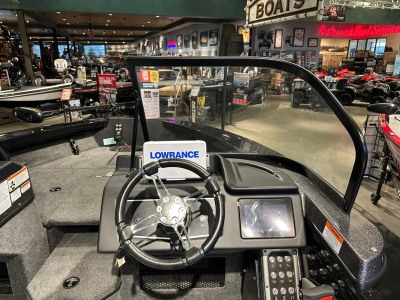 Slide: The Image of 2024 Ranger VX1788 WT boat interior with steering wheel and Lowrance navigation system. - 4