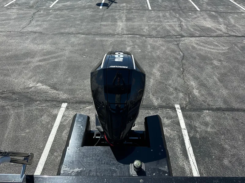 Slide: The Image of 2024 Regency 230 DL3 boat with Mercury 300 outboard engine in a parking lot. - 6