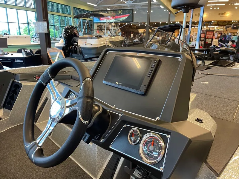 Slide: The Image of 2024 Ranger Z519 Garmin Ranger Cup boat dashboard with steering wheel and display. - 4