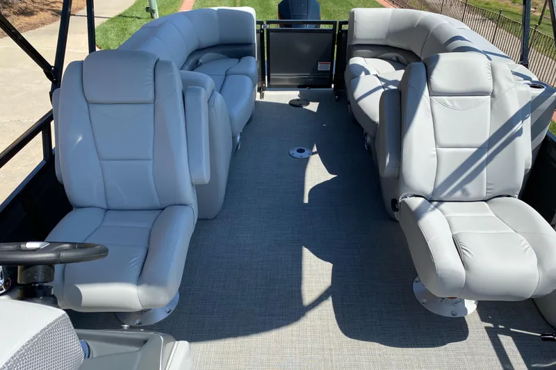 Slide: The Image of 2024 Regency 230 DL3 pontoon boat interior with plush gray seating. - 4