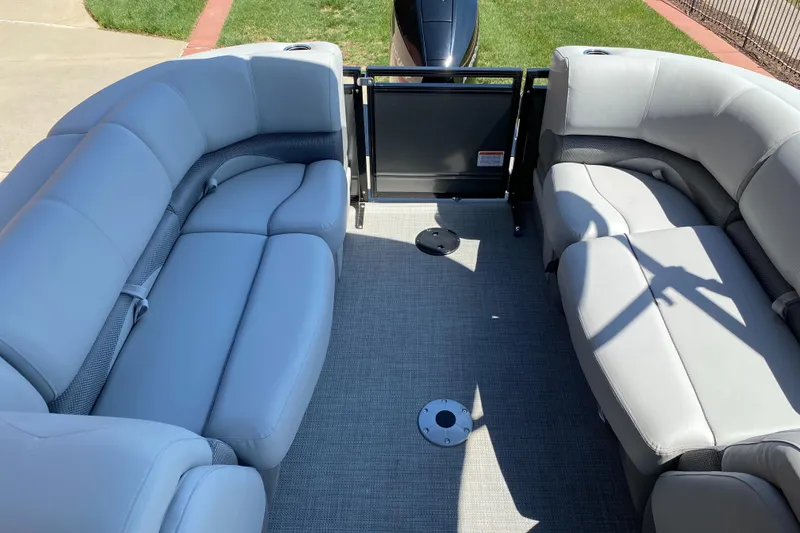 Slide: The Image of 2024 Regency 230 DL3 boat interior with gray seating and carpeted floor. - 5