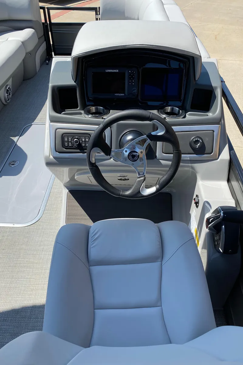 Slide: The Image of 2024 Regency 230 DL3 boat cockpit with modern steering and controls. - 6