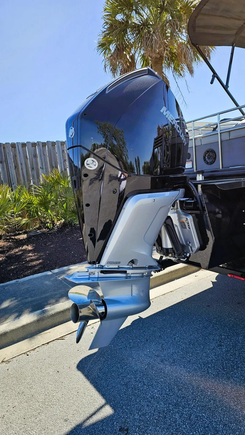 Slide: The Image of 2024 Regency 230 LE3 Sport boat engine, sleek design, outdoor setting. - 10