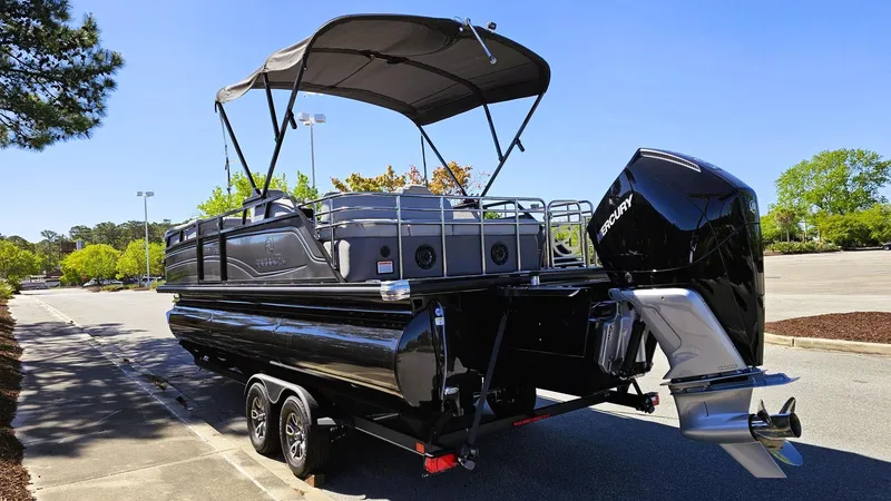 Slide: The Image of 2024 Regency 230 LE3 Sport pontoon boat with canopy and powerful outboard motor. - 6