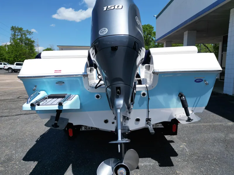 Slide: The Image of 2023 Tidewater 198CC boat with powerful outboard motor, parked outdoors on a sunny day. - 13