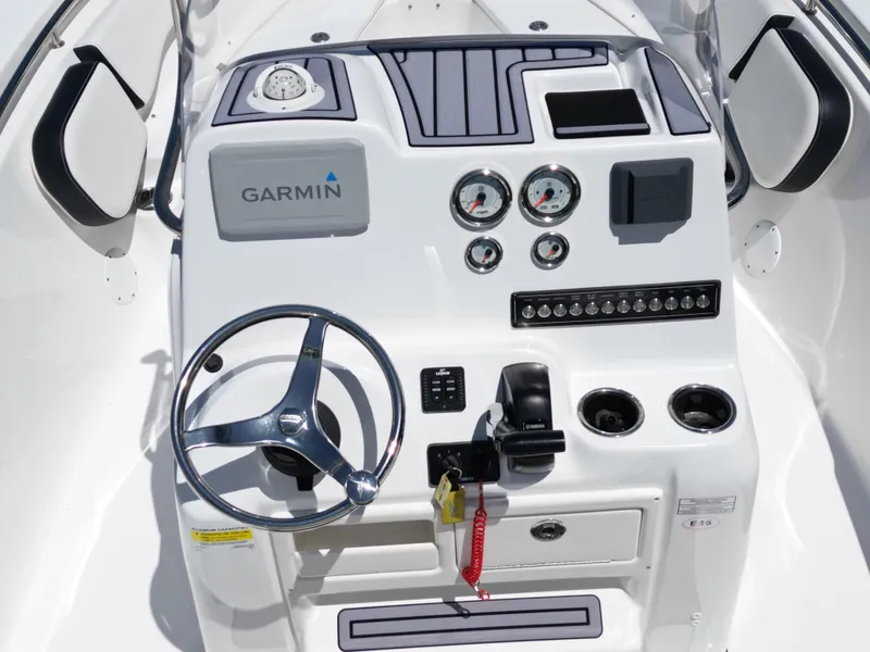 Slide: The Image of 2023 Tidewater 198CC boat dashboard with Garmin navigation, steering wheel, and control panel. - 19