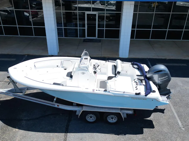 Slide: The Image of 2023 Tidewater 198CC boat on trailer, parked outside a building. - 3