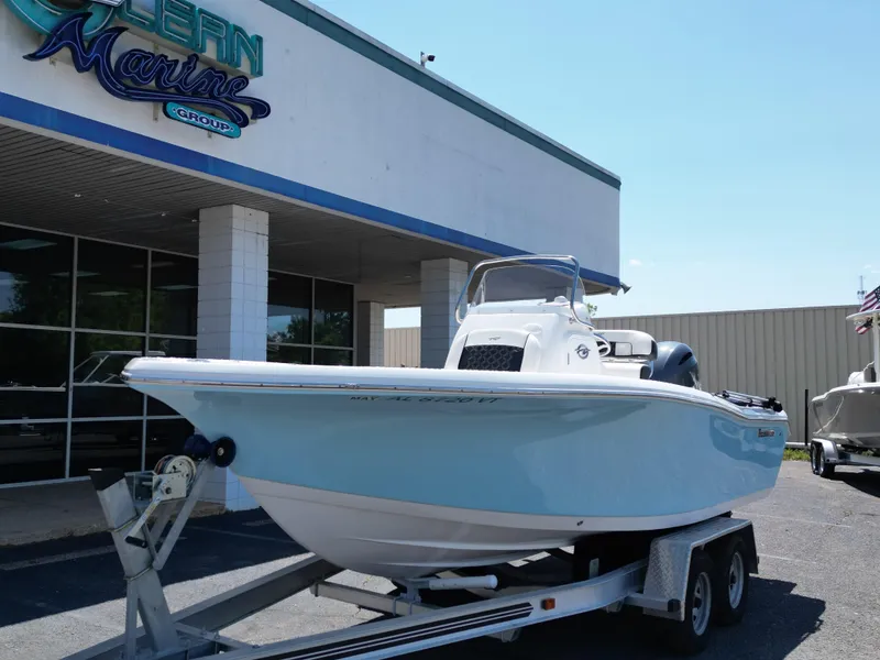 Slide: The Image of 2023 Tidewater 198CC boat on trailer outside dealership, sunny day. - 6