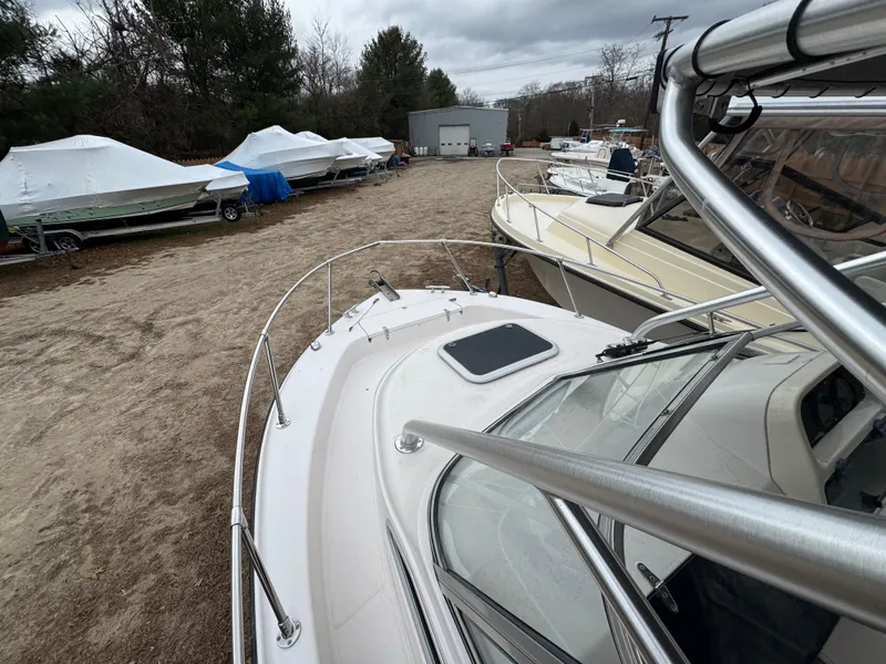 Slide: The Image of 2004 Grady-White Seafarer 228 boat in storage yard, surrounded by covered boats. - 10
