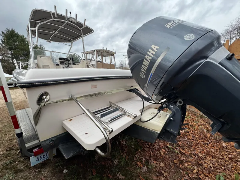 Slide: The Image of 2004 Grady-White Seafarer 228 boat with Yamaha outboard motor, parked on leaves. - 7