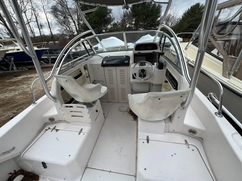 Slide: The Image of 2004 Grady-White Seafarer 228 boat interior with dual seats and steering console. - 9