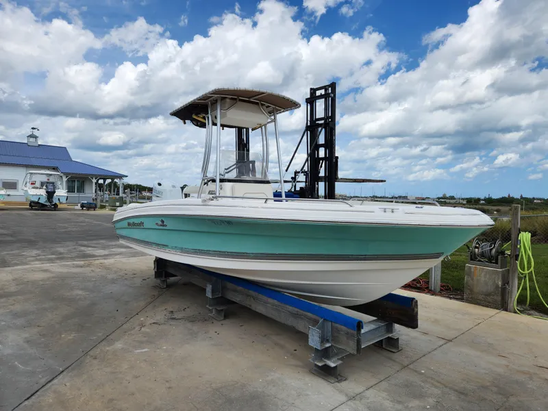 Slide: The Image of 2004 Wellcraft 200 LT Fisherman boat on trailer, parked outdoors under cloudy sky. - 1