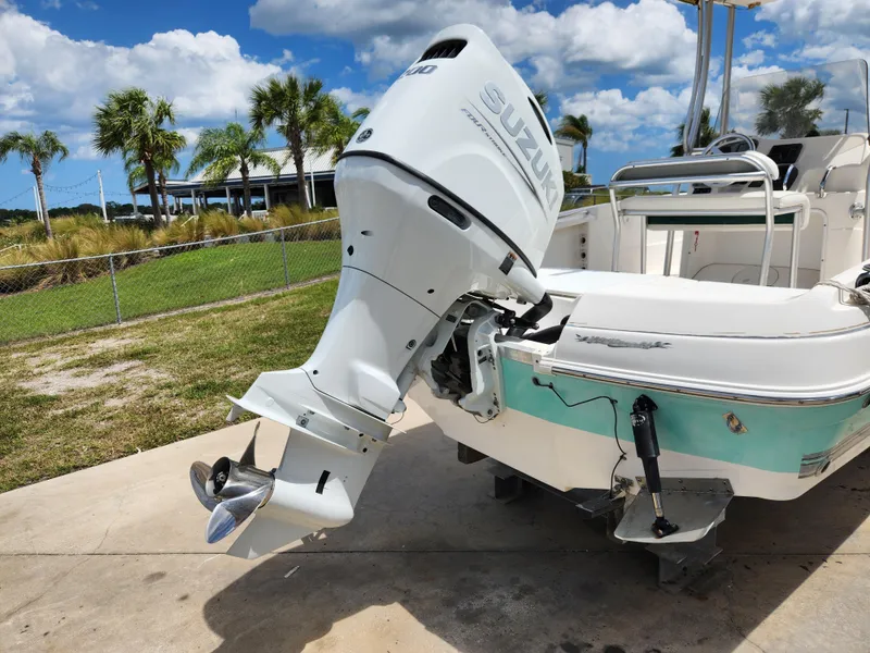 Slide: The Image of 2004 Wellcraft 200 LT Fisherman boat with Suzuki outboard motor, parked outdoors. - 11