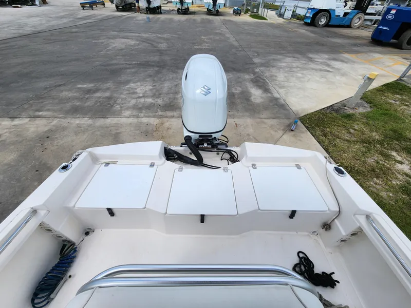 Slide: The Image of 2004 Wellcraft 200 LT Fisherman boat with Suzuki outboard motor, docked on concrete. - 22