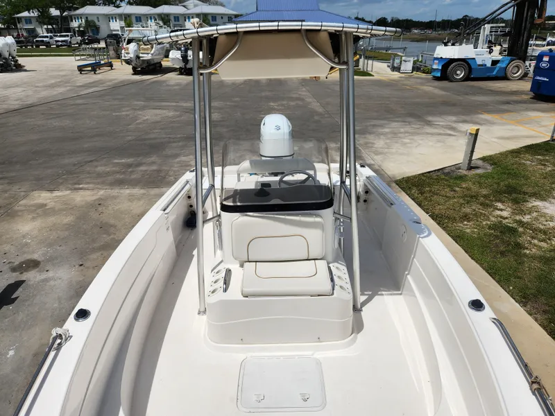 Slide: The Image of 2004 Wellcraft 200 LT Fisherman boat with center console and canopy, docked at marina. - 31