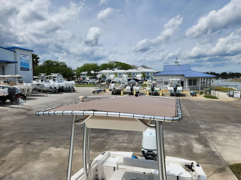 Slide: The Image of 2004 Wellcraft 200 LT Fisherman boat at a marina with cloudy skies. - 34