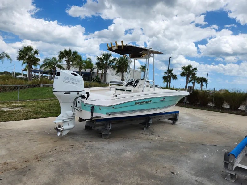 Slide: The Image of 2004 Wellcraft 200 LT Fisherman boat on trailer, parked outdoors under cloudy sky. - 4