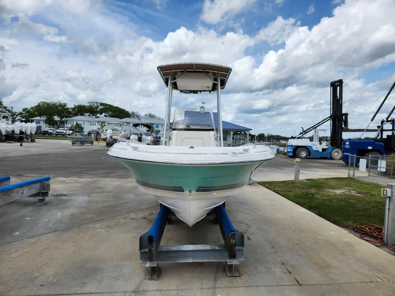 Slide: The Image of 2004 Wellcraft 200 LT Fisherman boat on trailer at marina, under cloudy sky. - 5
