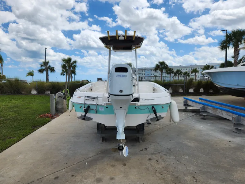 Slide: The Image of 2004 Wellcraft 200 LT Fisherman boat on trailer, parked outdoors under a cloudy sky. - 6
