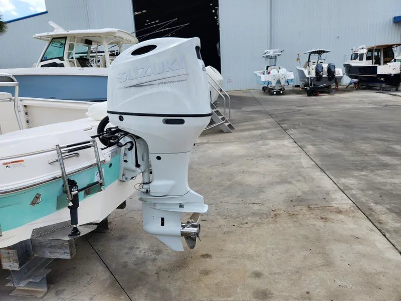 Slide: The Image of 2004 Wellcraft 200 LT Fisherman with Suzuki outboard motor in a boatyard. - 9