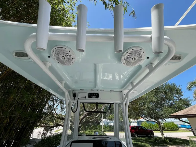Slide: The Image of 2018 Sea Hunt 255 SE boat with rod holders and speakers under T-top. - 13