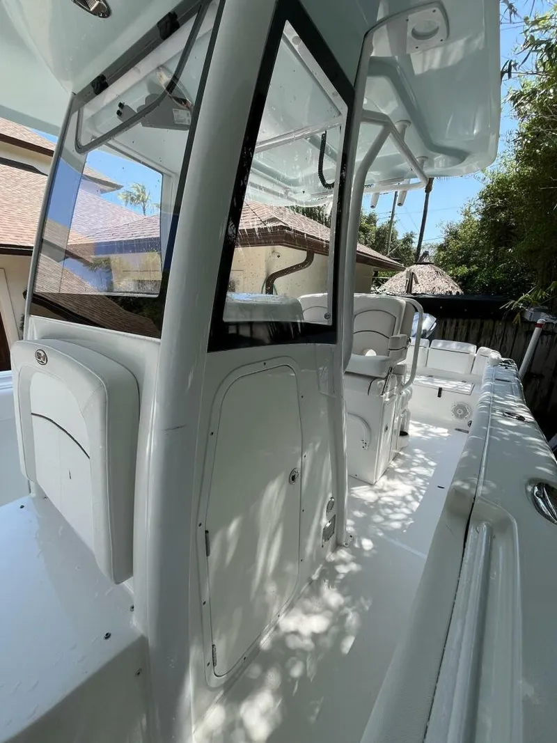 Slide: The Image of 2018 Sea Hunt 255 SE boat with sleek white interior and modern design. - 16