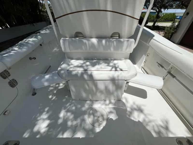 Slide: The Image of 2018 Sea Hunt 255 SE boat interior with white seating and storage compartments. - 27