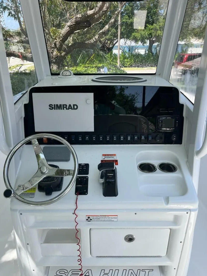 Slide: The Image of 2018 Sea Hunt 255 SE boat dashboard with Simrad navigation system and steering wheel. - 3