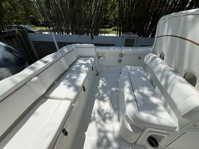 Slide: The Image of 2018 Sea Hunt 255 SE boat interior with white seating and shaded deck area. - 32