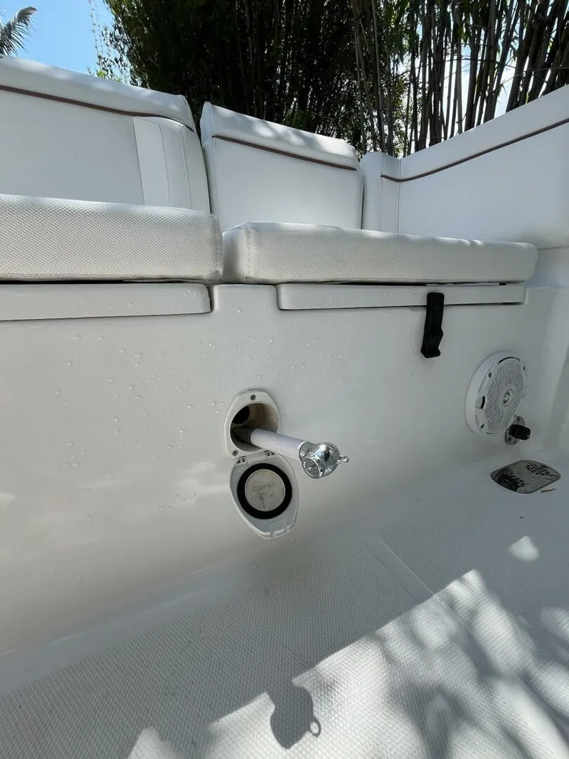 Slide: The Image of 2018 Sea Hunt 255 SE boat interior with white seating and stainless steel fixtures. - 33