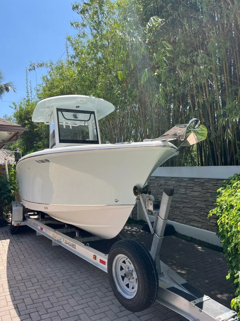 Slide: The Image of 2018 Sea Hunt 255 SE boat on trailer, surrounded by greenery. - 39