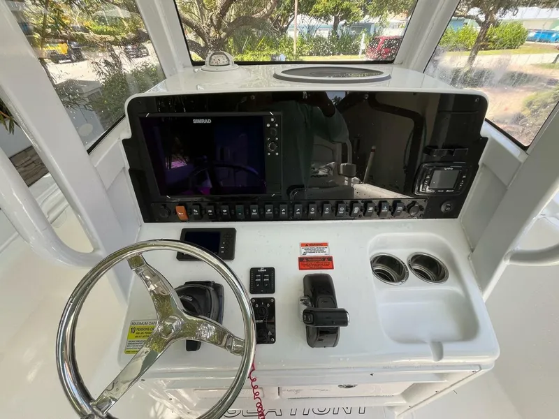 Slide: The Image of 2018 Sea Hunt 255 SE boat dashboard with steering wheel and navigation controls. - 4