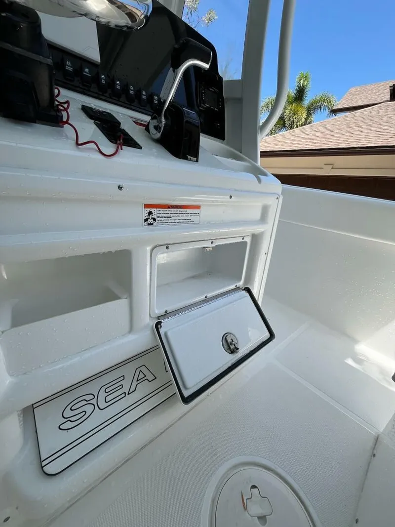 Slide: The Image of 2018 Sea Hunt 255 SE boat interior with storage compartment and control panel. - 6