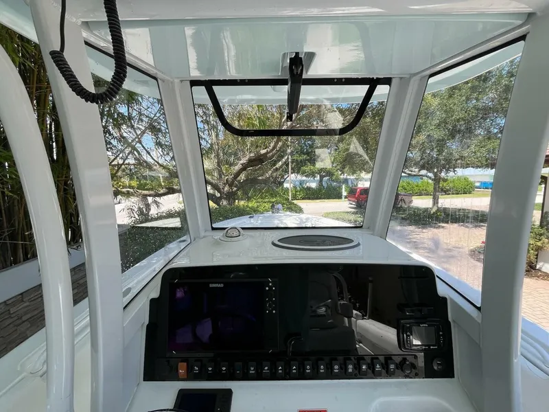 Slide: The Image of 2018 Sea Hunt 255 SE boat dashboard with navigation controls and windshield view. - 7