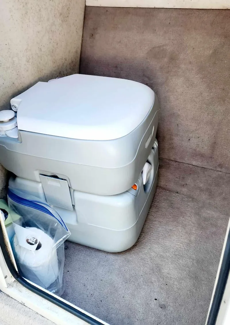 Slide: The Image of Portable toilet inside a 1996 Crownline 266 BR boat cabin. - 11