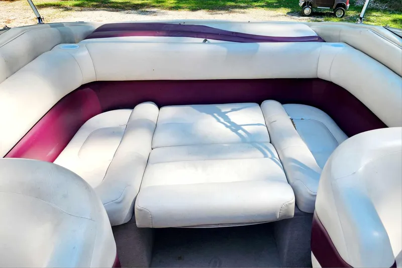 Slide: The Image of Interior seating of a 1996 Crownline 266 BR boat with white and maroon upholstery. - 8