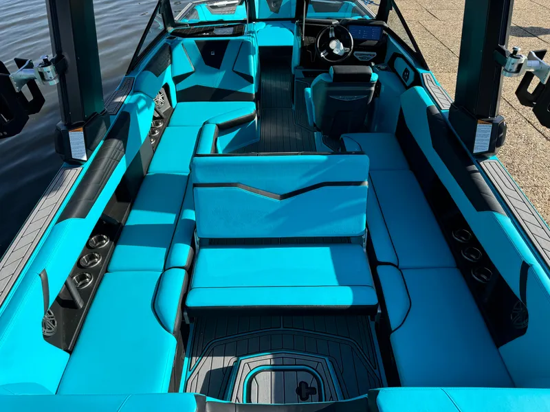 Slide: The Image of 2023 Nautique Super Air Nautique S25 interior with vibrant blue seating and modern design. - 10