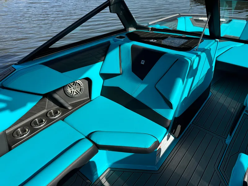 Slide: The Image of 2023 Nautique Super Air Nautique S25 interior with turquoise seating and sleek design. - 11