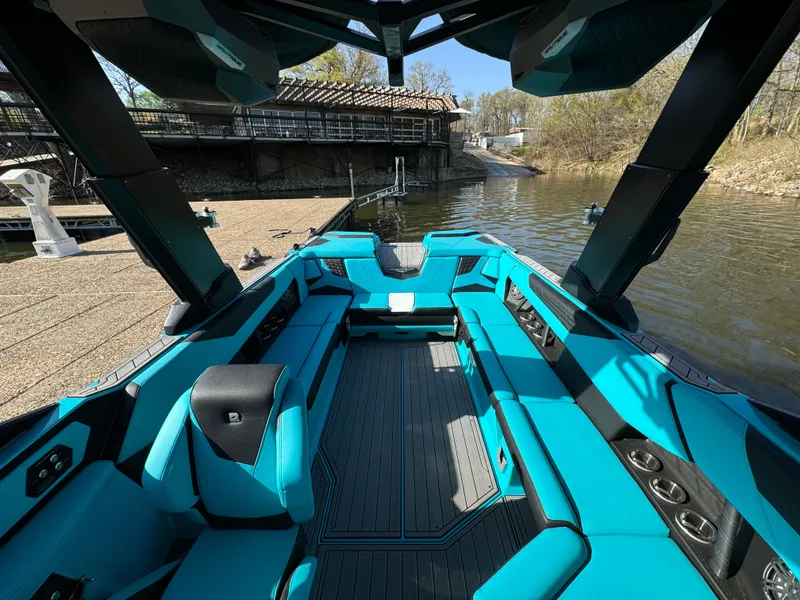 Slide: The Image of 2023 Nautique Super Air Nautique S25 boat interior with turquoise seating and sleek design. - 20