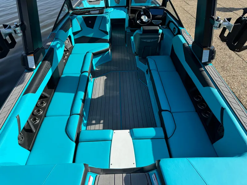 Slide: The Image of 2023 Nautique Super Air Nautique S25 interior with turquoise seating and sleek design. - 7