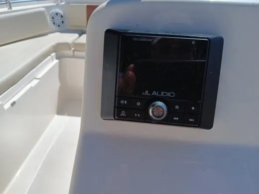 Slide: The Image of 2021 Cobia 220 Dual Console boat with JL Audio system. - 2
